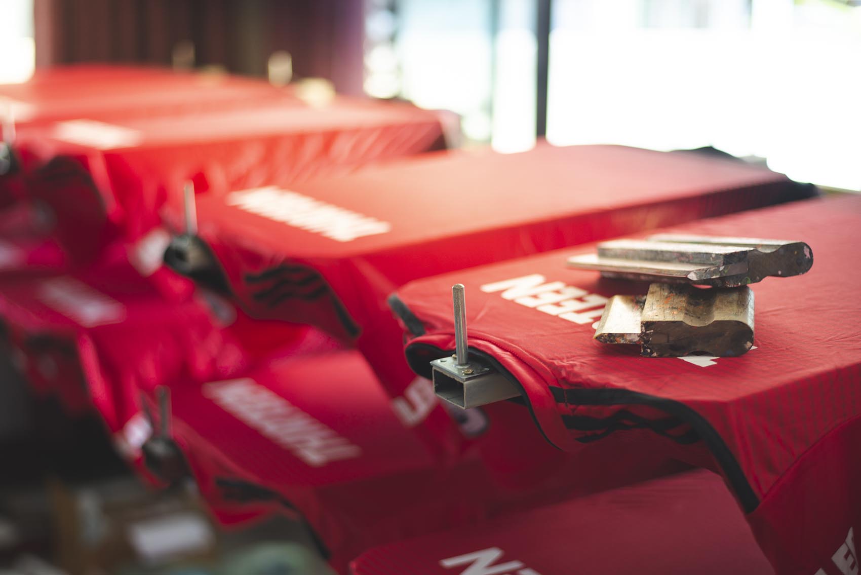 Red t-shirt screen printing, worker working on manual screen pri
